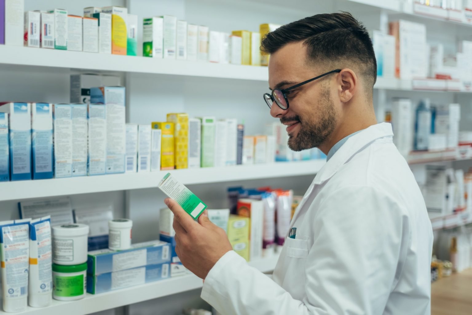 handsome pharmacist working in a pharmacy 1536x1025 1